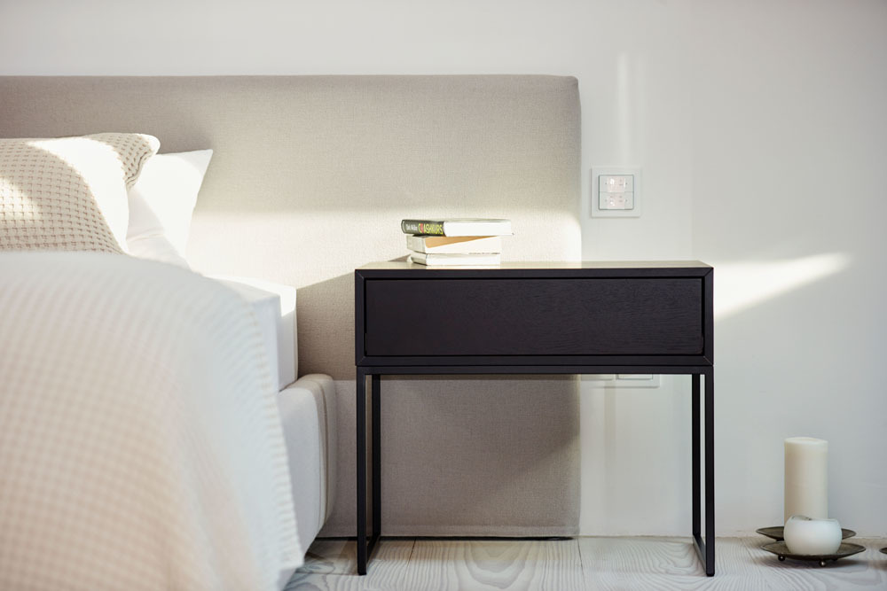 Schwarzer Dina Beistelltisch von Jan Kurtz aus Esche neben einem Bett mit Nachttischlampe.