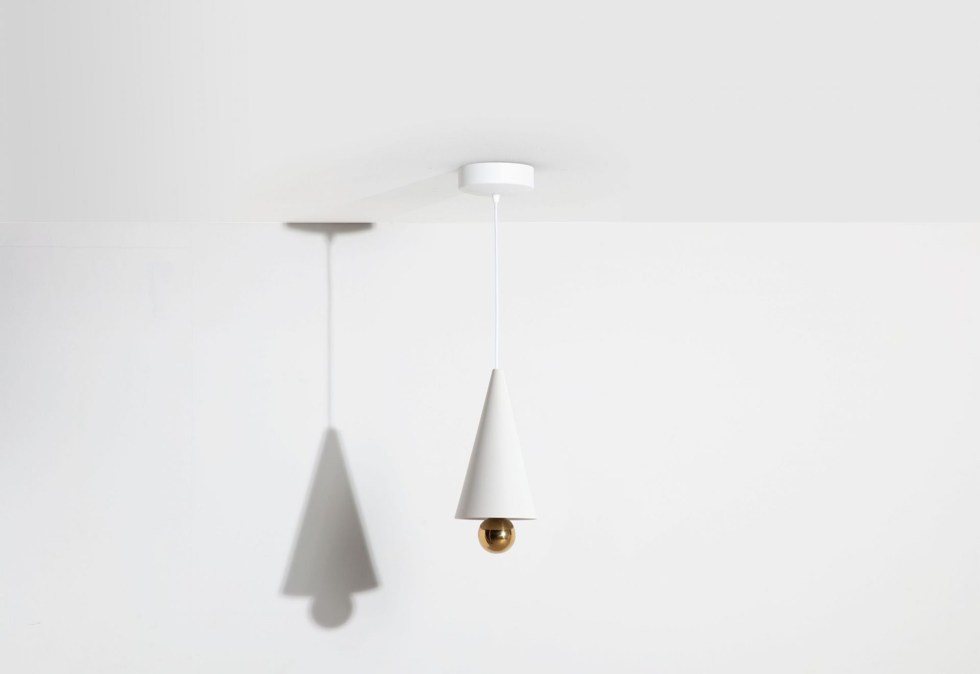 Weiße Cherry Pendelleuchte von Petite Friture mit Kegelform und goldener Kugel.