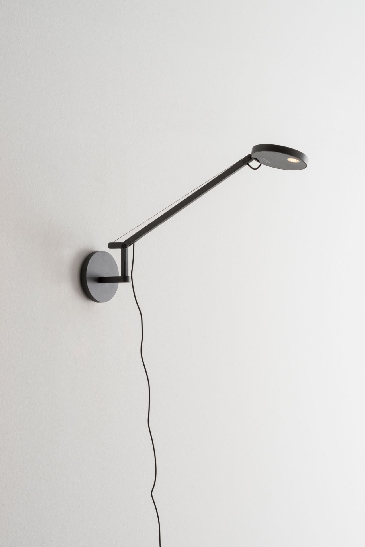 Anthrazitgraue Demetra Micro Wandleuchte von Artemide mit verstellbarem Arm und LED-Licht. Wandlampe für Schlafzimmer.
